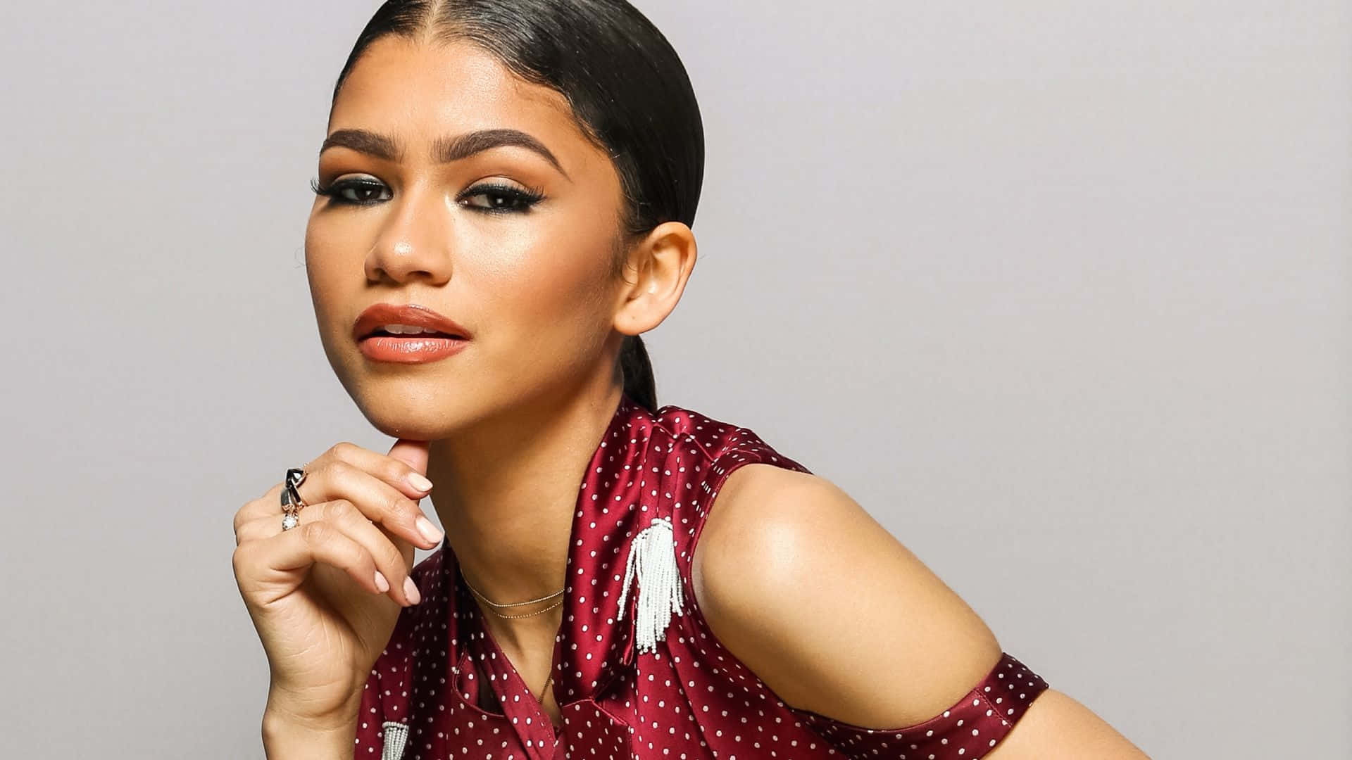 Zendaya, red polka-dot top, gray studio background, Full HD Desktop Wallpaper