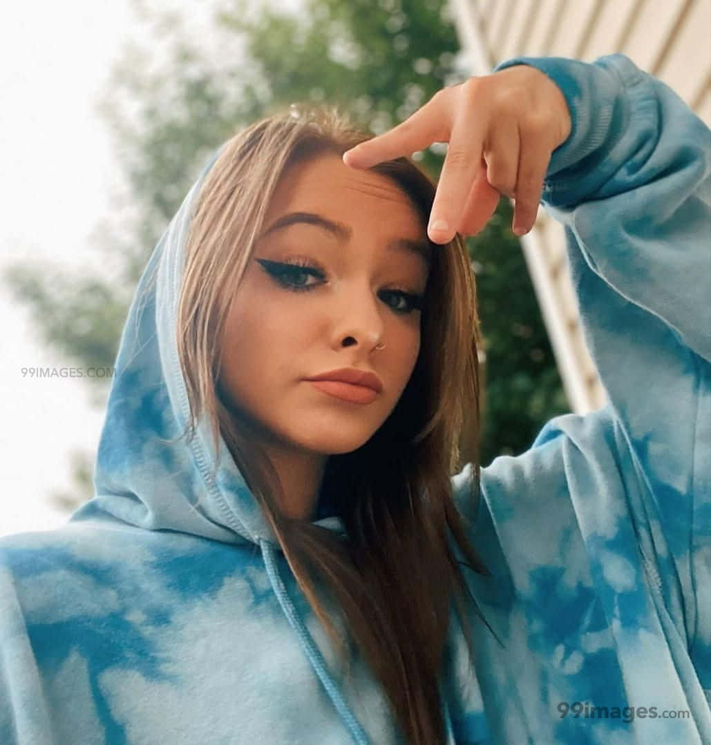Zoe Laverne, blue tie-dye hoodie, hand near forehead, SD Phone Wallpaper